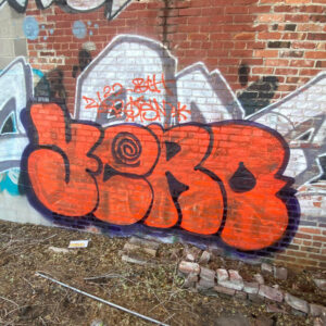 Orange graffiti on wall by Yero member of Bless theHomies crew